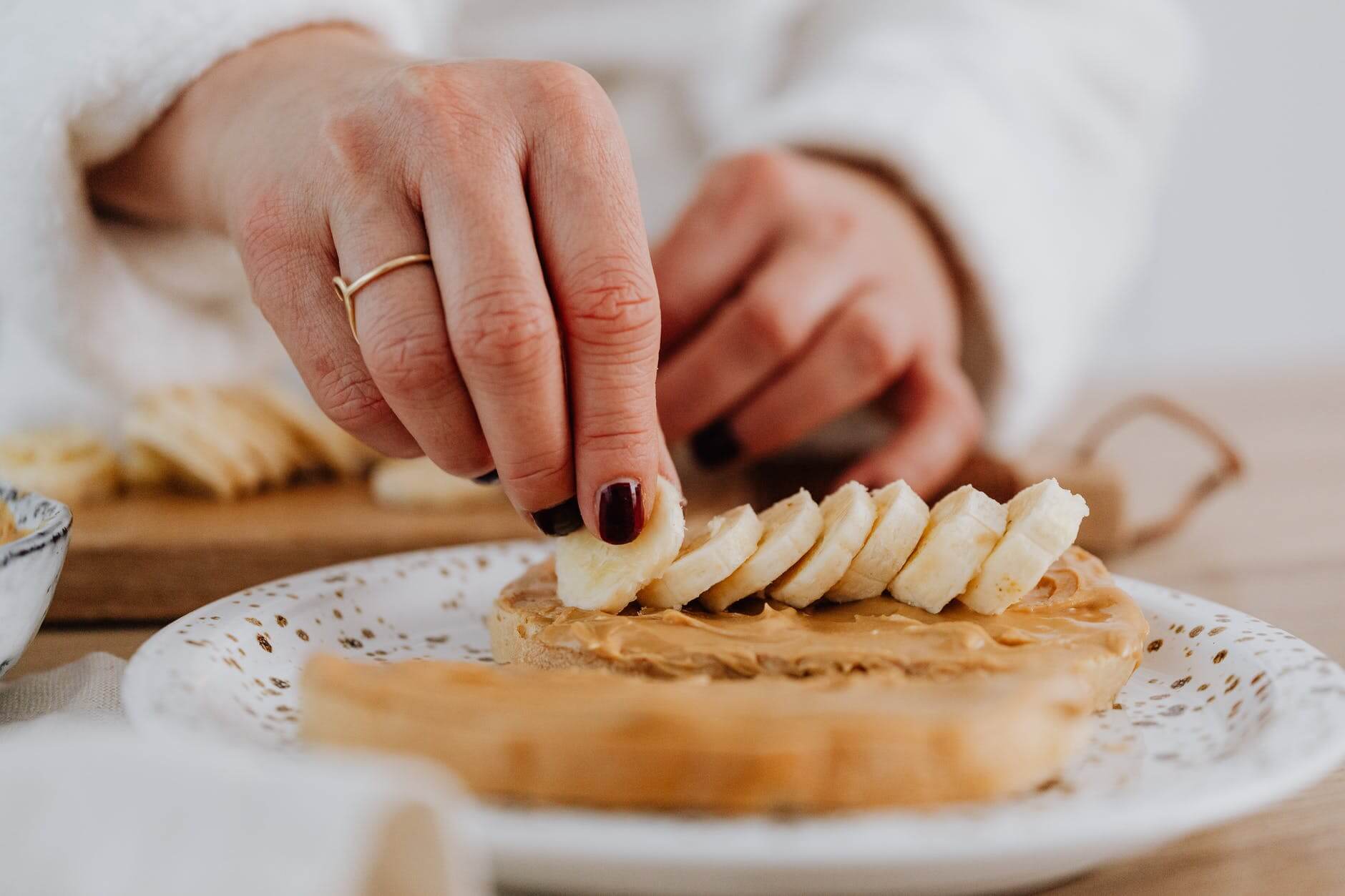 putting of banana slices on toast